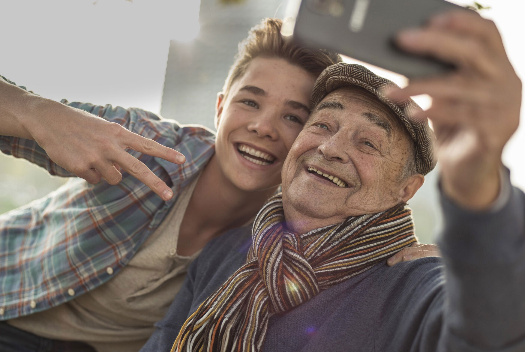 Older man and youth taking selfie photo